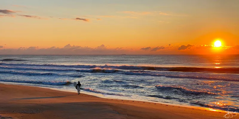 A Lone Surfer in the Morning Sun